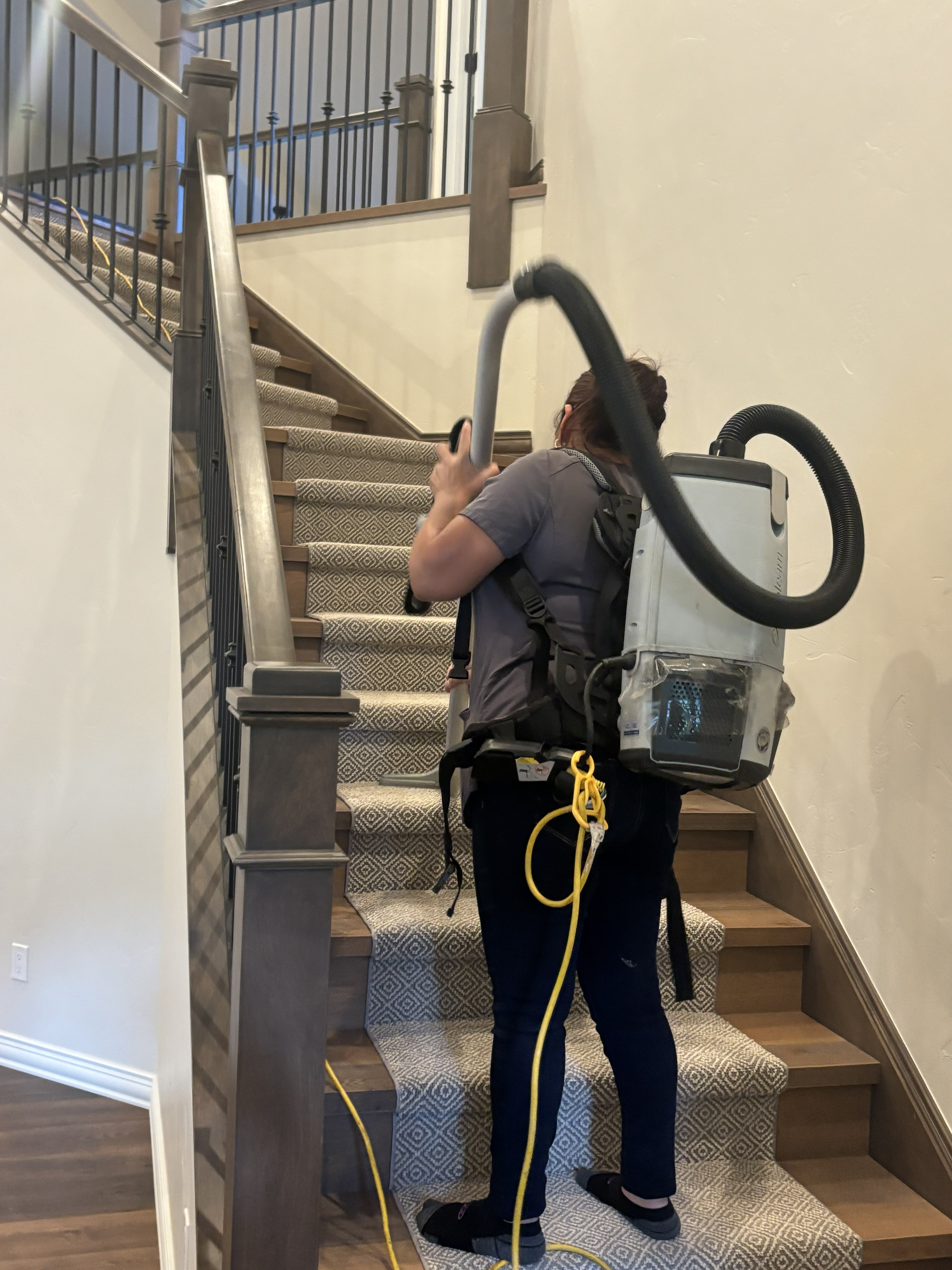 Professional staircase cleaning with backpack vacuum in luxury home — Eagle County Colorado